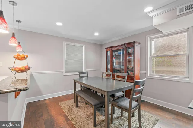 a dining room with wooden floor and breakfast area