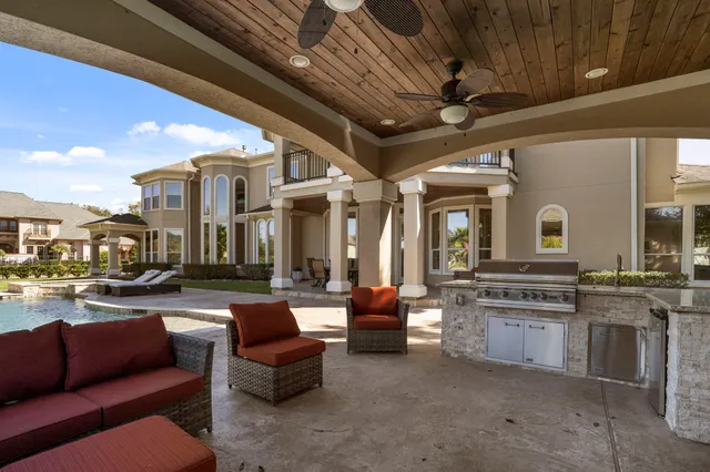 a outdoor space with patio couches and a fireplace