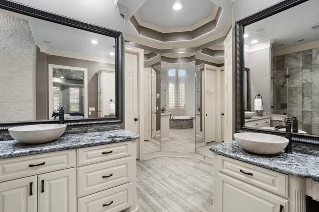 a spacious bathroom with a granite countertop sink mirror and vanity