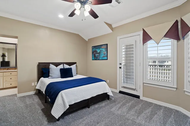 a spacious bedroom with a bed and a window