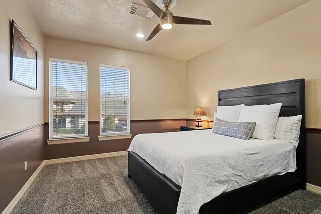 a bedroom with a large bed and a large window