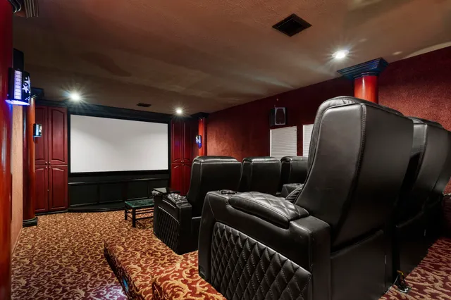 a media room with lots of chairs and a projector screen