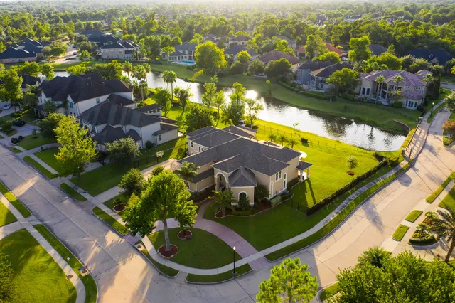 an aerial view of residential houses with outdoor space