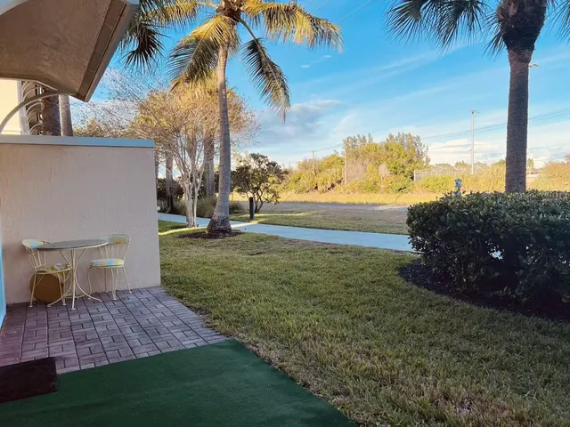 a view of a yard and front view of a house