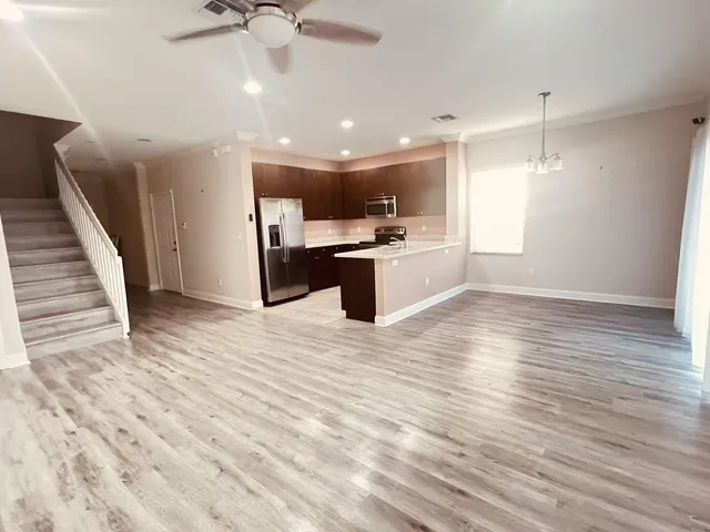 a view of a kitchen with a sink and microwave