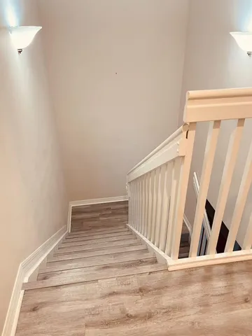 a view of a room with wooden floor and stairs