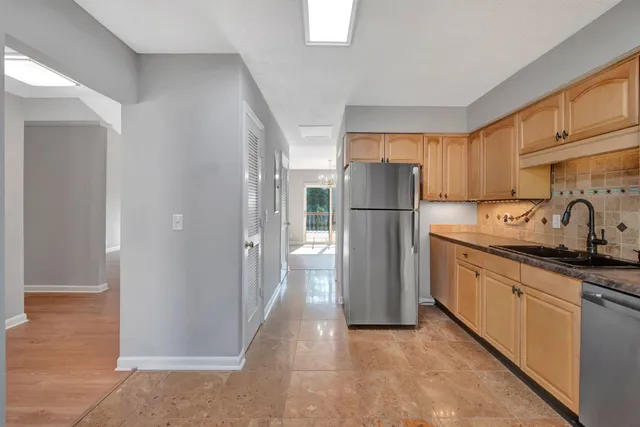 a kitchen with stainless steel appliances a refrigerator and a sink