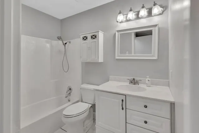 a bathroom with a sink toilet tub and shower