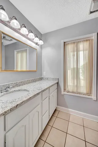 a bathroom with a sink a vanity and a mirror