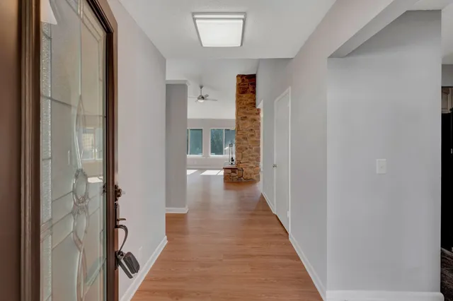 a view of a hallway with a livingroom and furniture