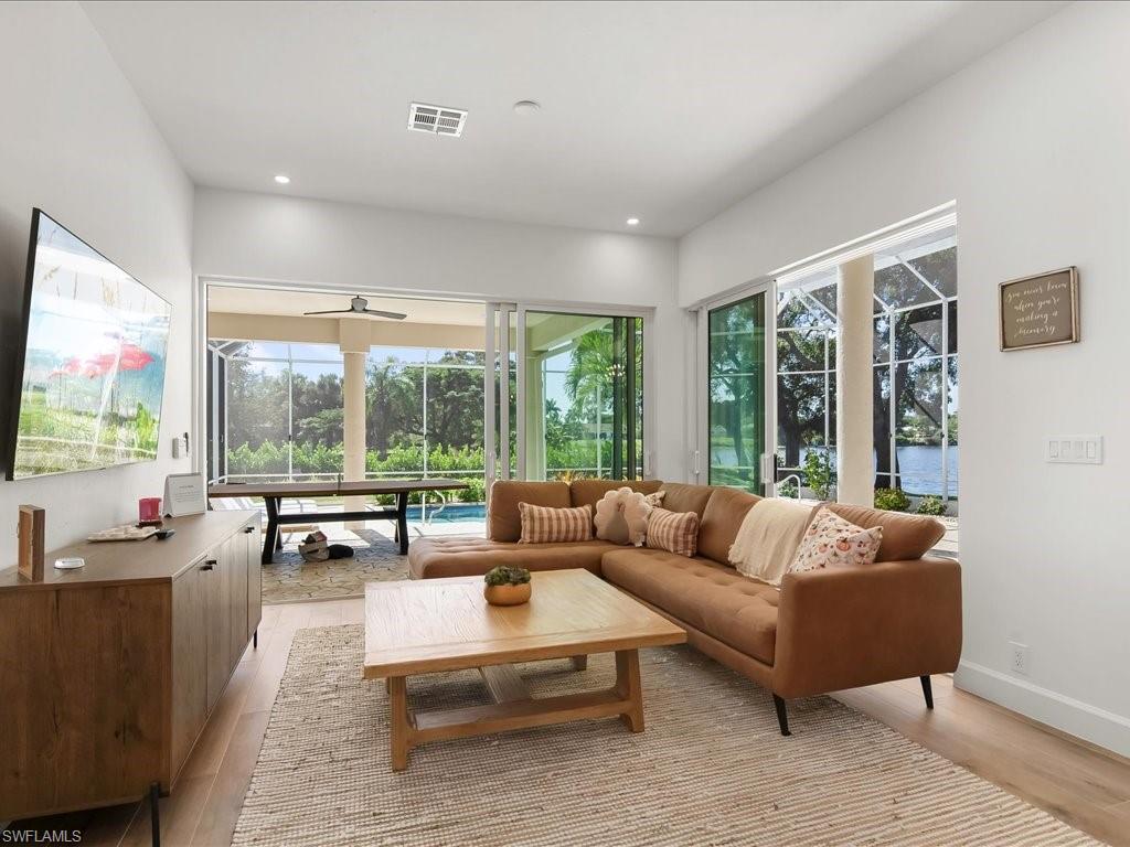 2115 Imperial Golf Course Boulevard Naples, FL 34110 - Photo 15 of 50 a living room with furniture and large windows