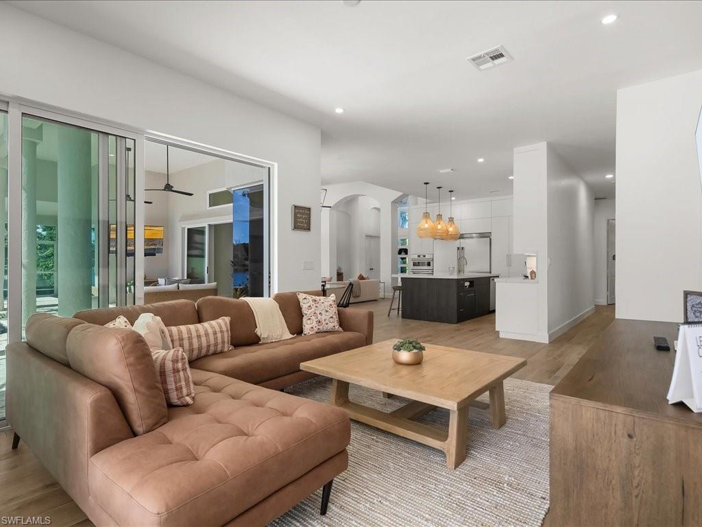 2115 Imperial Golf Course Boulevard Naples, FL 34110 - Photo 16 of 50 a living room with furniture and wooden floor