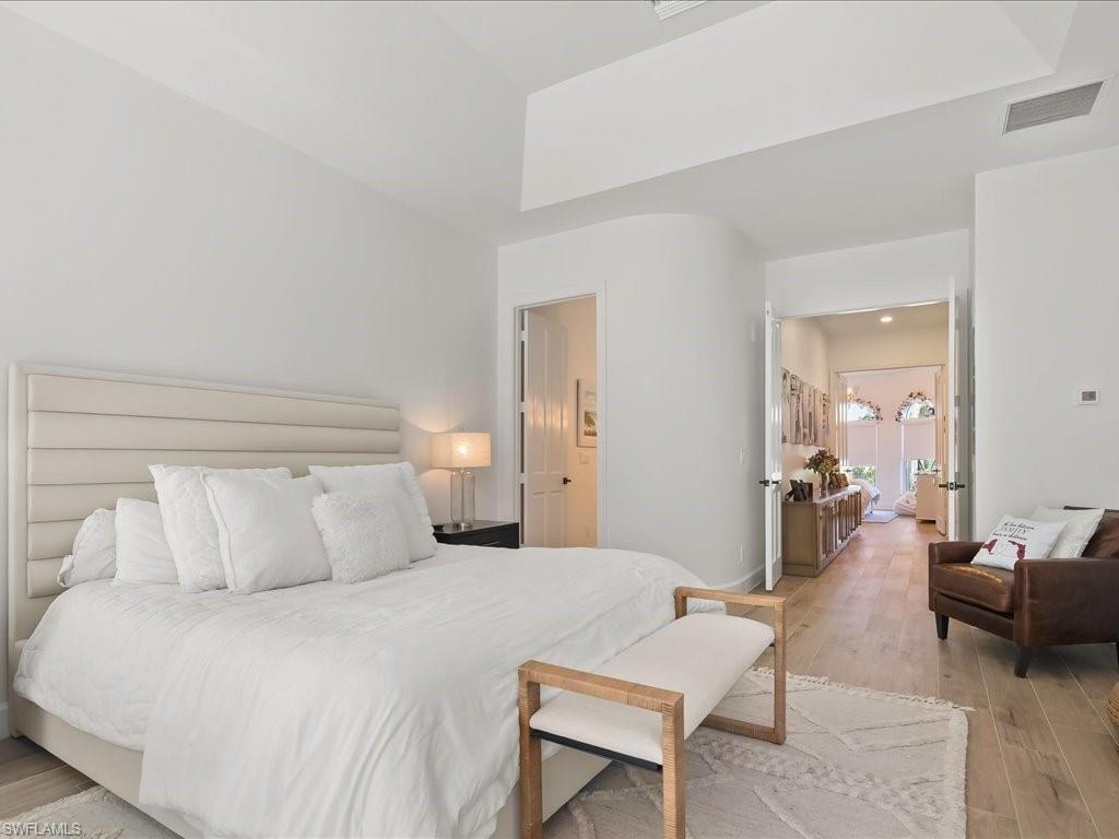 2115 Imperial Golf Course Boulevard Naples, FL 34110 - Photo 20 of 50 a bedroom with a bed and couch
