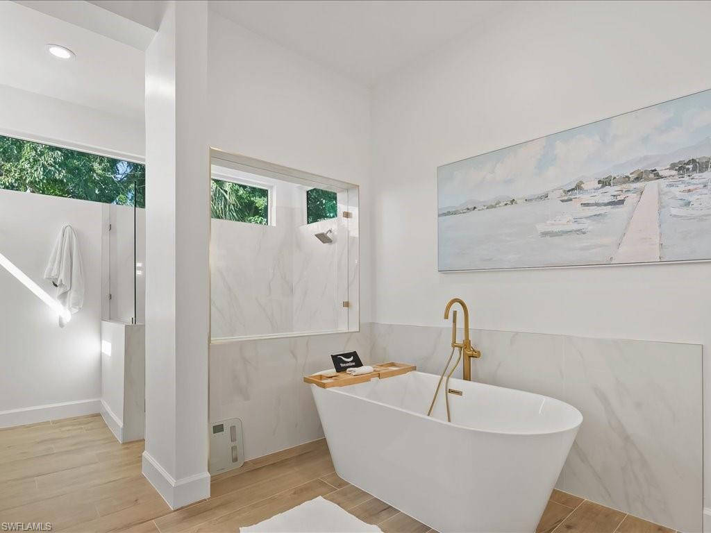 2115 Imperial Golf Course Boulevard Naples, FL 34110 - Photo 22 of 50 a white bath tub sitting next to a white sink