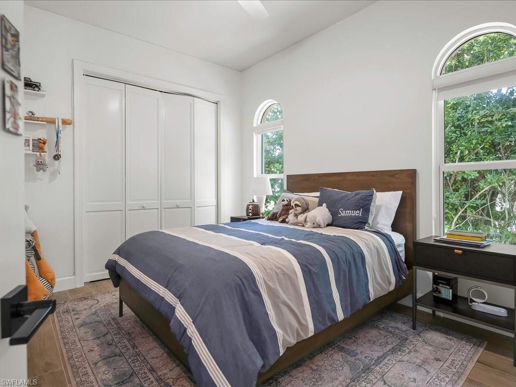 2115 Imperial Golf Course Boulevard Naples, FL 34110 - Photo 27 of 50 a bedroom with a bed and a window