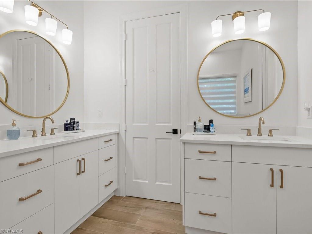 2115 Imperial Golf Course Boulevard Naples, FL 34110 - Photo 29 of 50 a bathroom with double vanity sink and a mirror