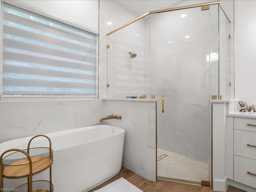 2115 Imperial Golf Course Boulevard Naples, FL 34110 - Photo 30 of 50 a bathroom with a bathtub and shower
