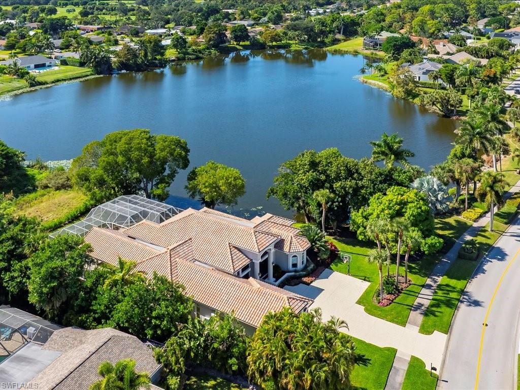 2115 Imperial Golf Course Boulevard Naples, FL 34110 - Photo 3 of 50 an aerial view of a house with a lake view