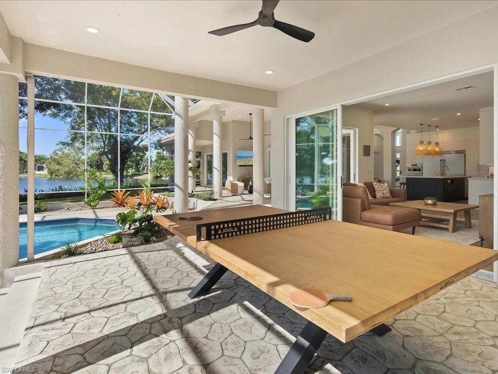 2115 Imperial Golf Course Boulevard Naples, FL 34110 - Photo 35 of 50 a living room with patio pool table and a large window