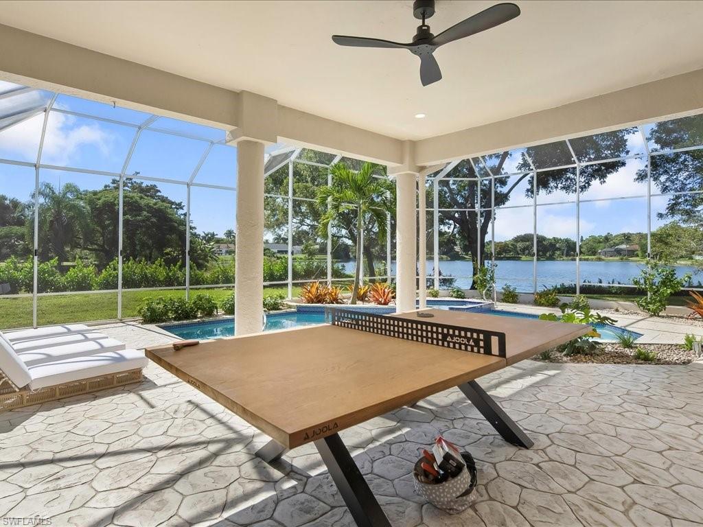 2115 Imperial Golf Course Boulevard Naples, FL 34110 - Photo 36 of 50 a living room with couch and a floor to ceiling window