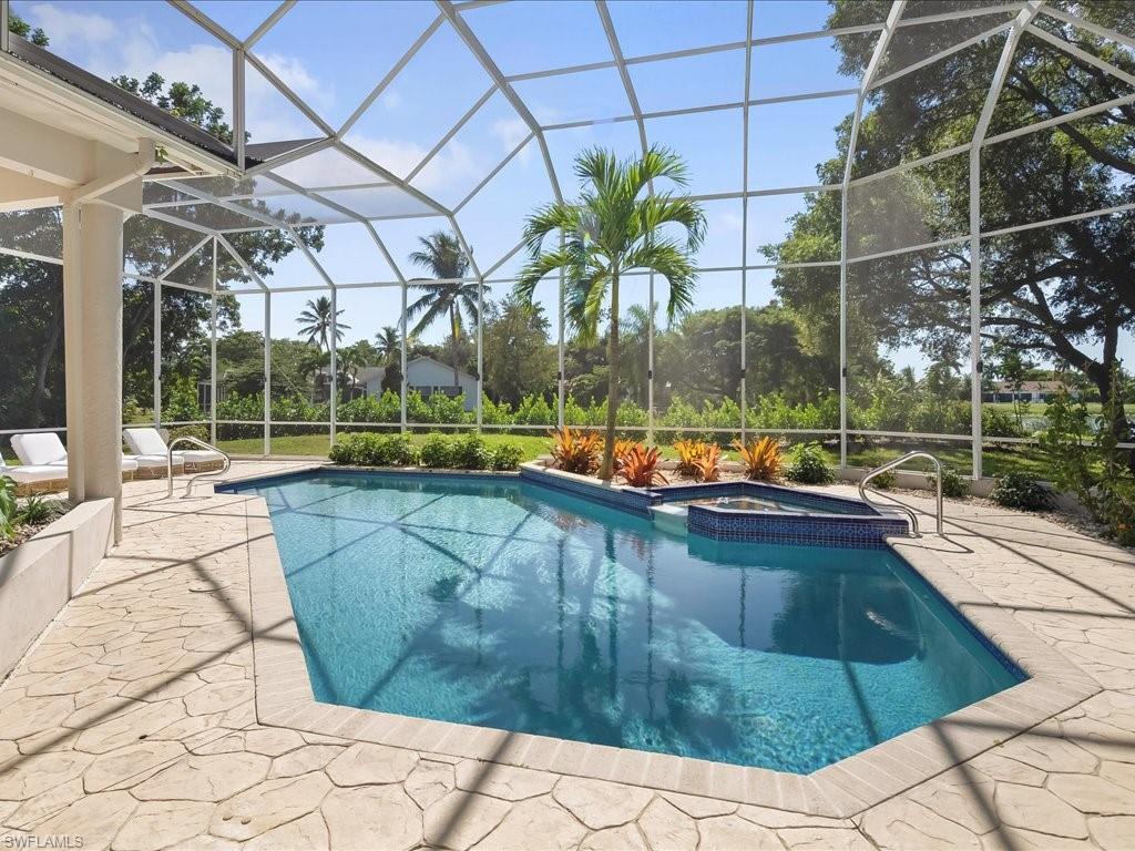 2115 Imperial Golf Course Boulevard Naples, FL 34110 - Photo 38 of 50 a view of a swimming pool with a patio