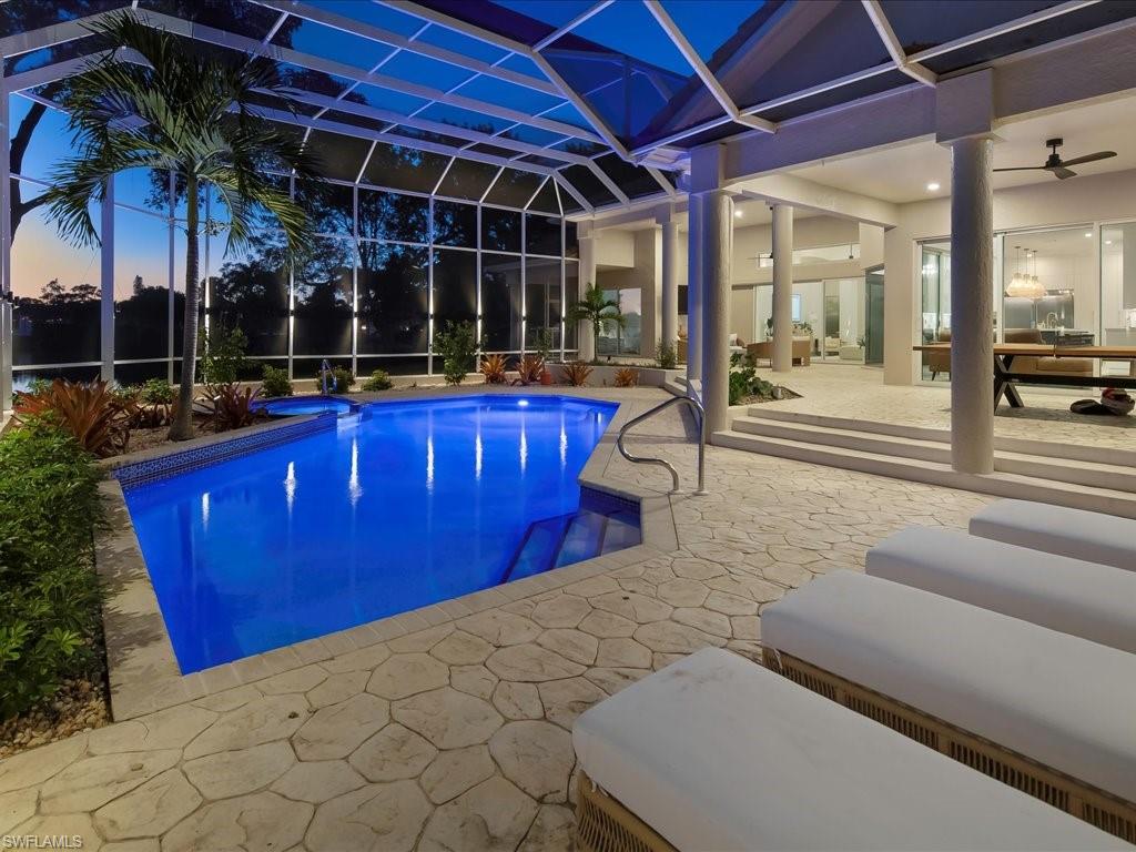 2115 Imperial Golf Course Boulevard Naples, FL 34110 - Photo 47 of 50 a view of a patio with a table and chairs