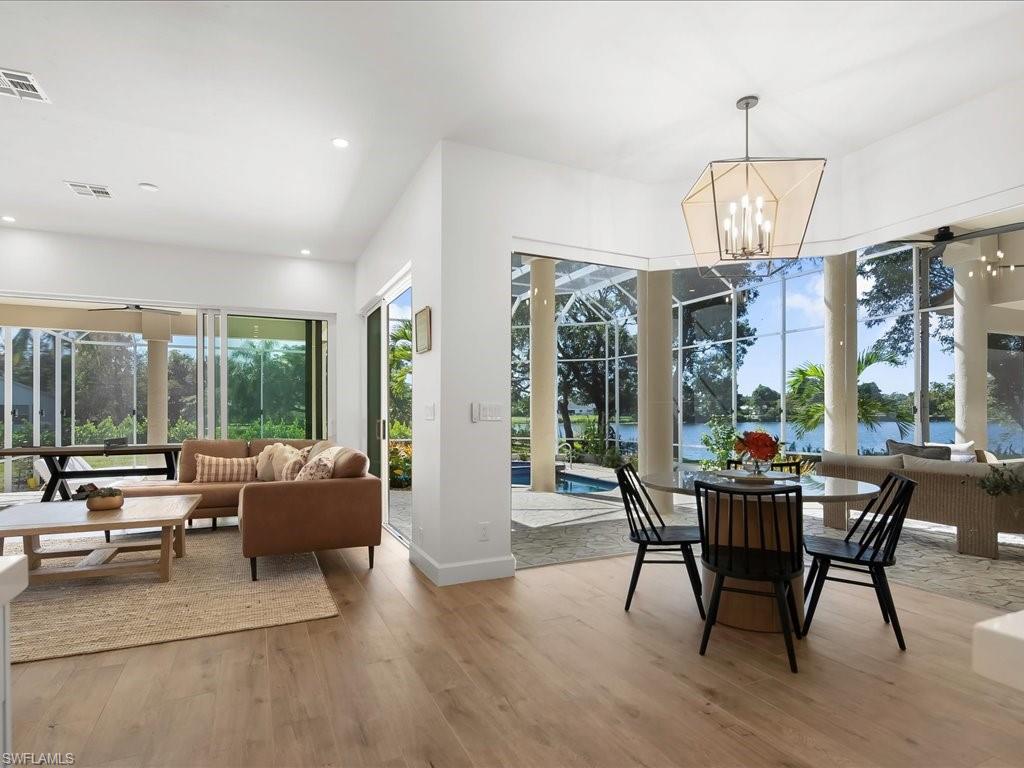 2115 Imperial Golf Course Boulevard Naples, FL 34110 - Photo 5 of 50 a view of a dining room with furniture large windows and wooden floor