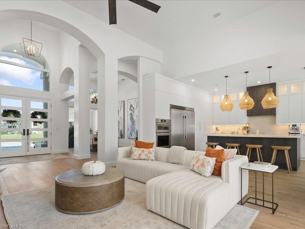 2115 Imperial Golf Course Boulevard Naples, FL 34110 - Photo 9 of 50 a living room with furniture and a fireplace