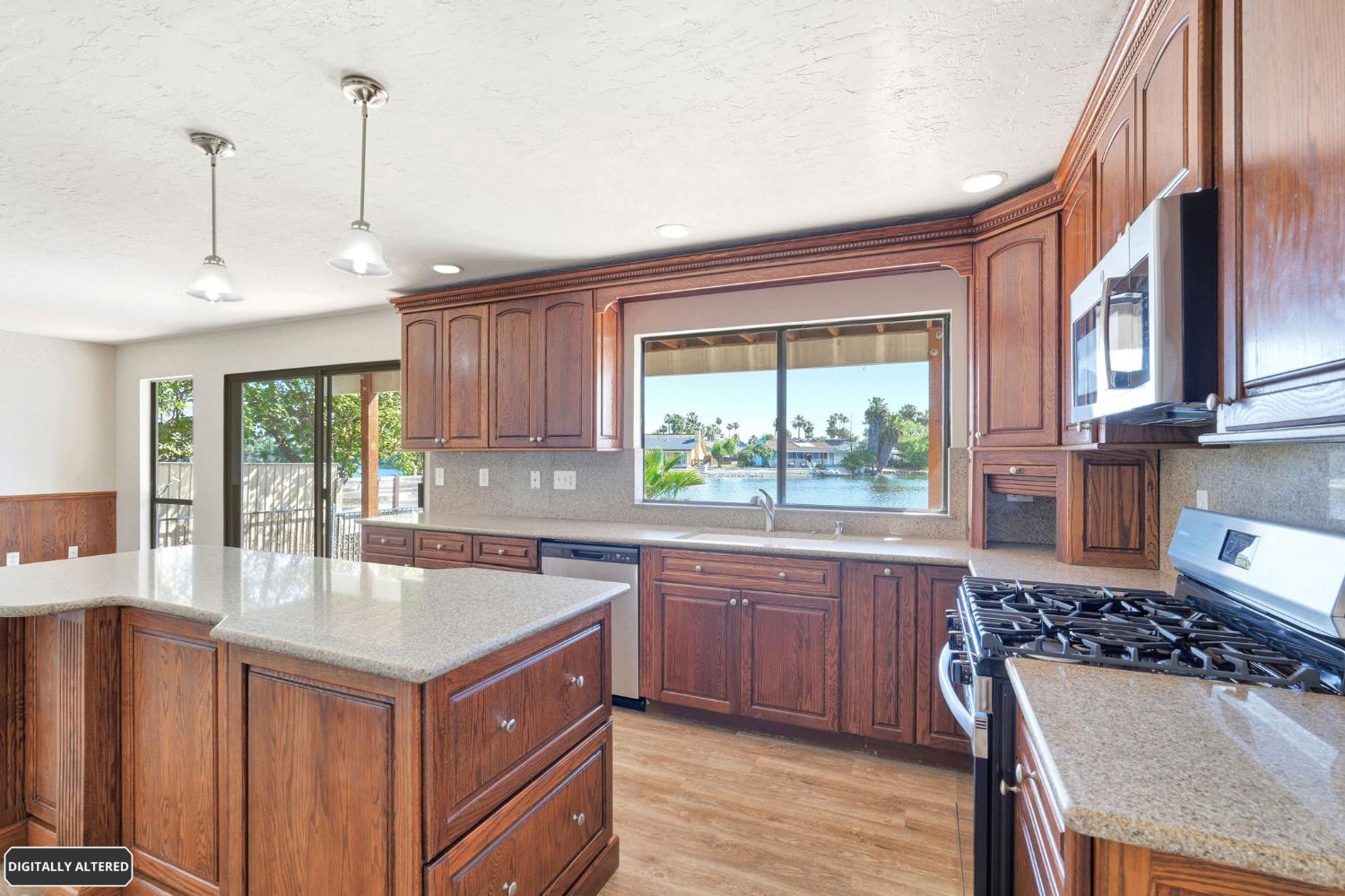 5501 Riverlake Road Discovery Bay, CA 94505 - Photo 24 of 60 a kitchen with kitchen island granite countertop a sink stove and refrigerator