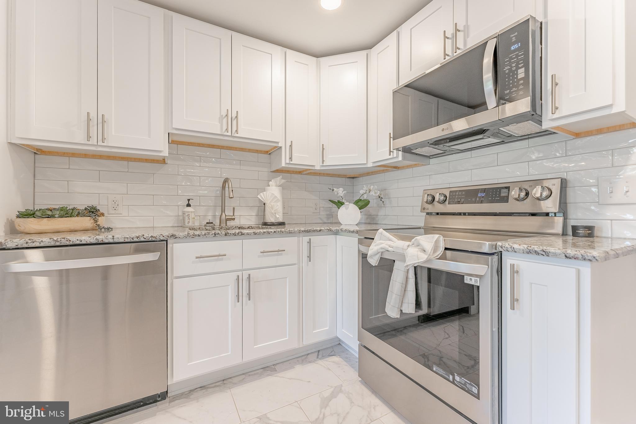 515 Park Road Spring City, PA 19475 - Photo 20 of 38 a kitchen with stainless steel appliances granite countertop a sink stove and cabinets
