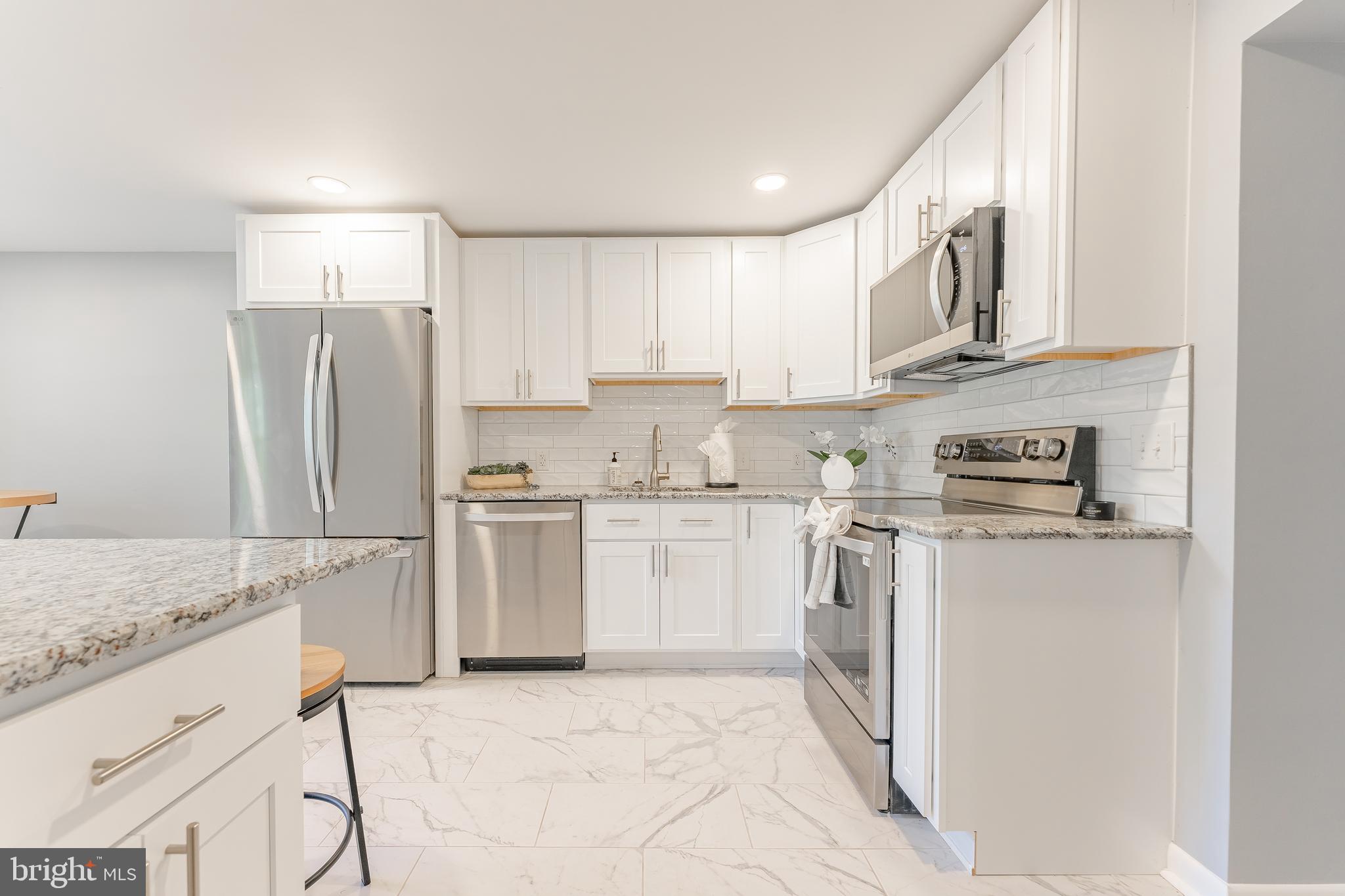 515 Park Road Spring City, PA 19475 - Photo 21 of 38 a kitchen with stainless steel appliances granite countertop a refrigerator sink and stove