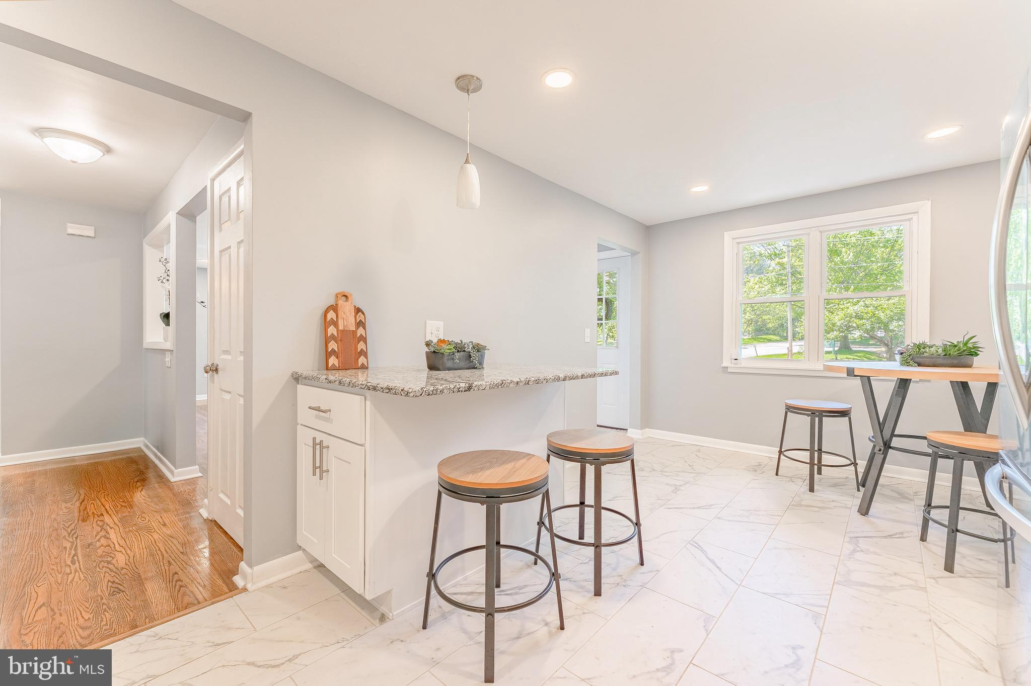 515 Park Road Spring City, PA 19475 - Photo 22 of 38 a kitchen with stainless steel appliances kitchen island granite countertop a table and chairs in it