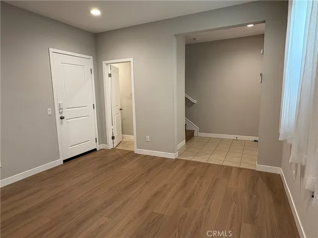 a view of a room with wooden floor and white doors