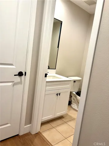 a bathroom with a sink a mirror and a toilet