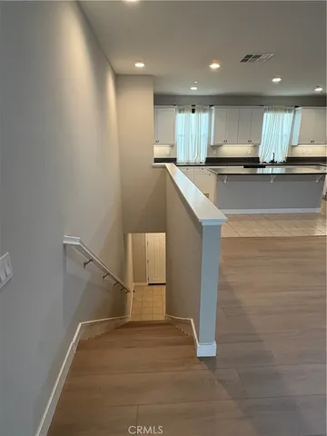 a view of kitchen with refrigerator sink and cabinets