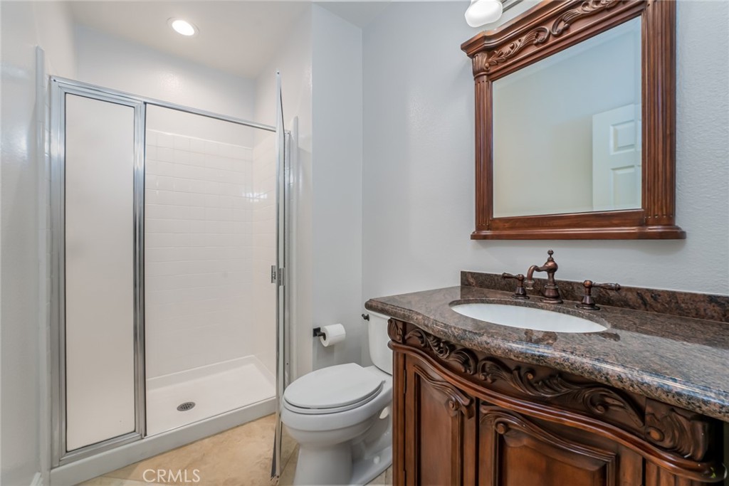 19 Springbrook Road Laguna Niguel, CA 92677 - Photo 13 of 50 a bathroom with a granite countertop sink a toilet mirror and vanity