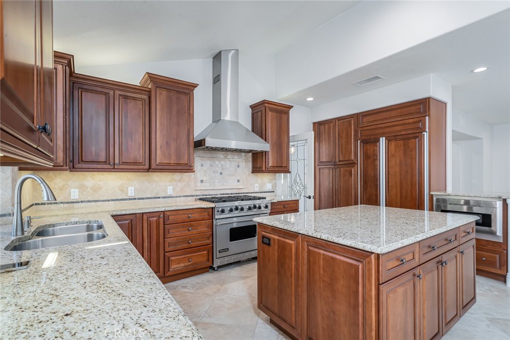 19 Springbrook Road Laguna Niguel, CA 92677 - Photo 18 of 50 a kitchen with stainless steel appliances granite countertop a sink stove and refrigerator