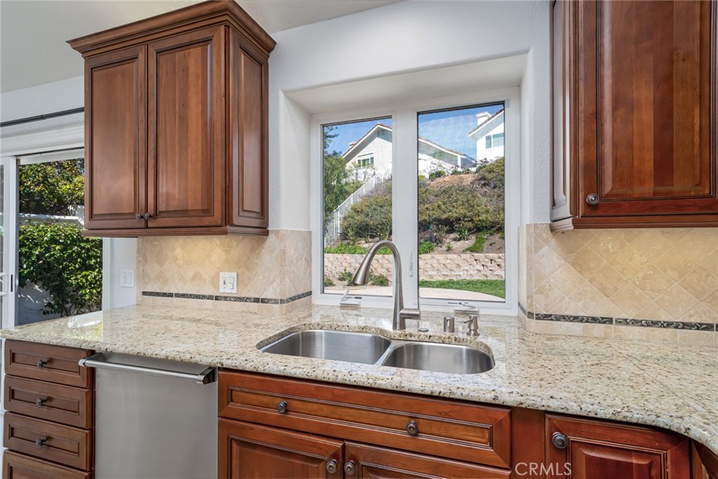 19 Springbrook Road Laguna Niguel, CA 92677 - Photo 20 of 50 a kitchen with granite countertop a sink a counter space and cabinets