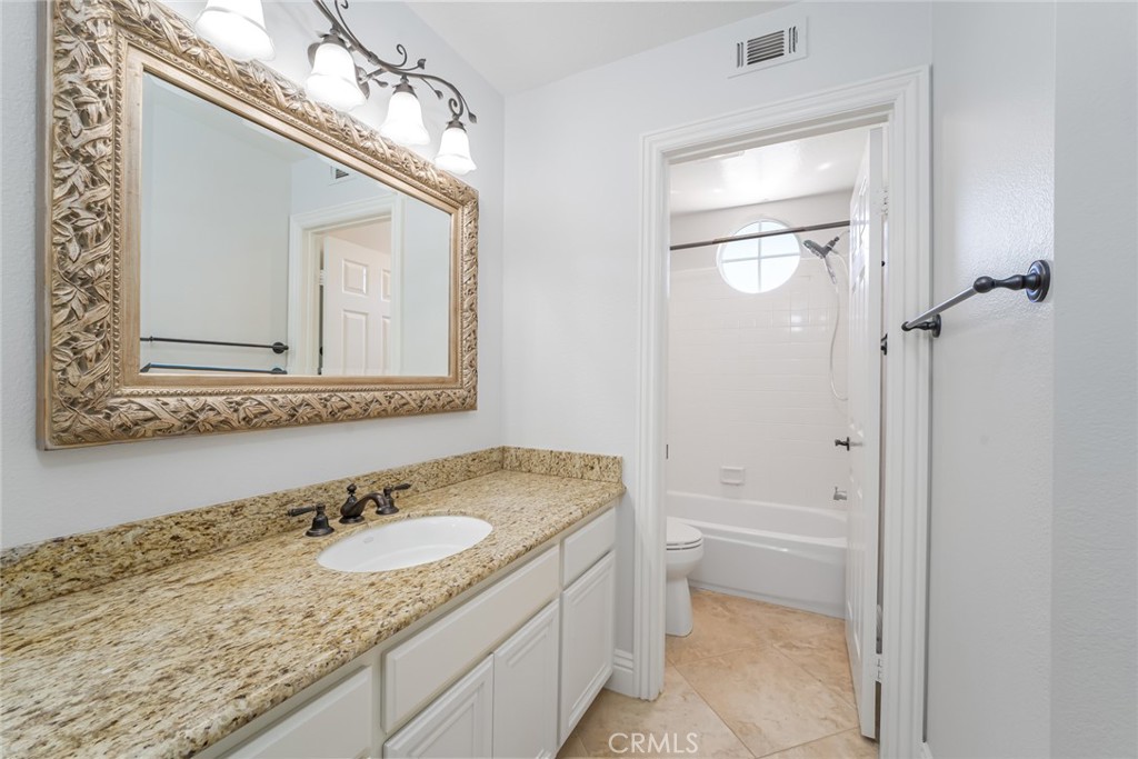 19 Springbrook Road Laguna Niguel, CA 92677 - Photo 29 of 50 a bathroom with a granite countertop sink mirror and a toilet