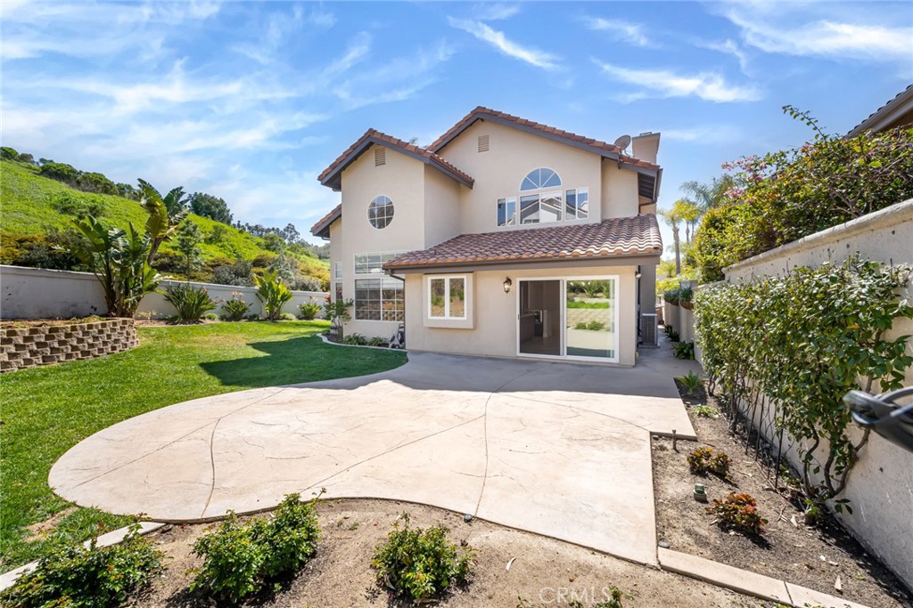 19 Springbrook Road Laguna Niguel, CA 92677 - Photo 34 of 50 a view of a white house with a yard and potted plants