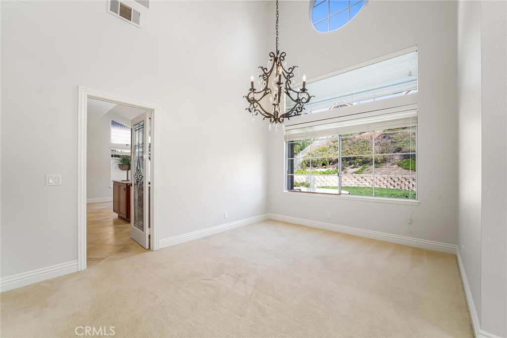 19 Springbrook Road Laguna Niguel, CA 92677 - Photo 9 of 50 an empty room with chandelier fan and windows