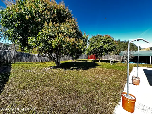 a view of a patio with a table and chairs