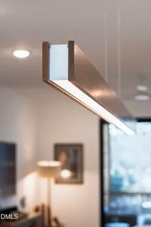 a view of a dining room with furniture and a chandelier