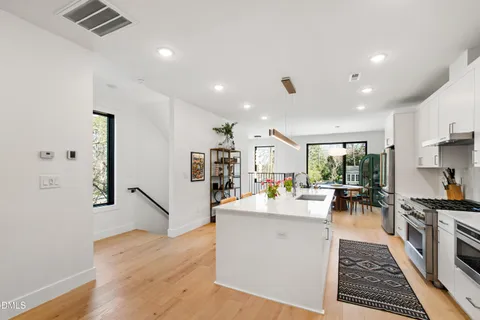 a dining room with furniture a painting and wooden floor