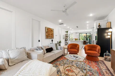 a living room with furniture ceiling fan and a rug