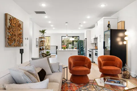 a living room with furniture and a lamp