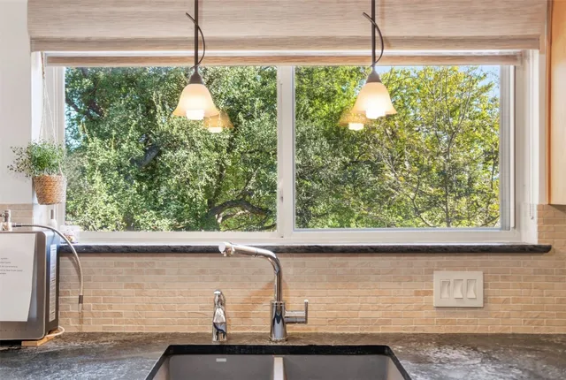 a sink with a window and outside view