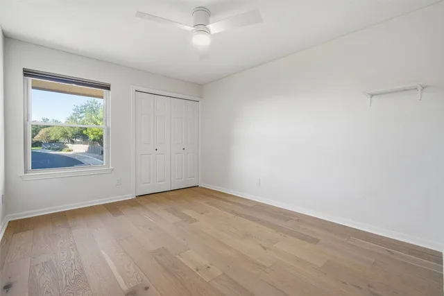 wooden floor in an empty room with a window