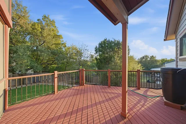 a view of a balcony with wooden floor