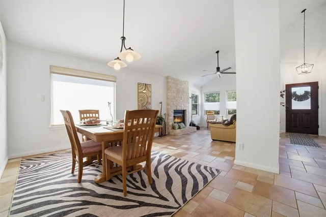 a view of a dining room and livingroom with furniture wooden floor a chandelier
